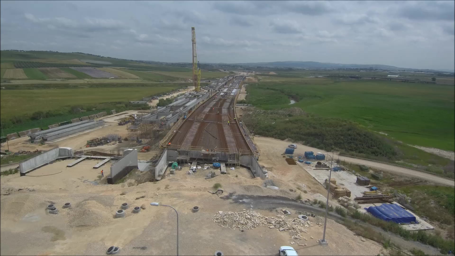 Highway construction site with a crane and concrete structure